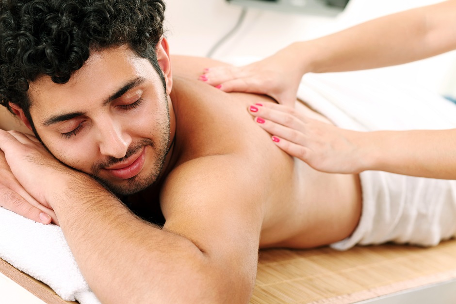 Handsome guy enjoying massage therapy